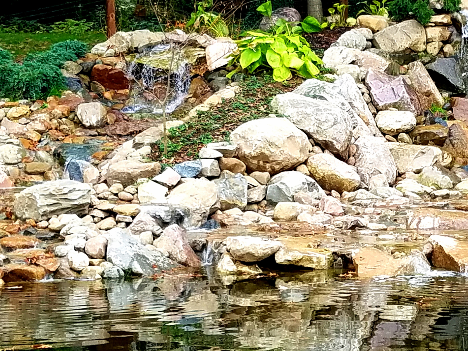 The stairstep falls is on the left, divided by a strip of plantings