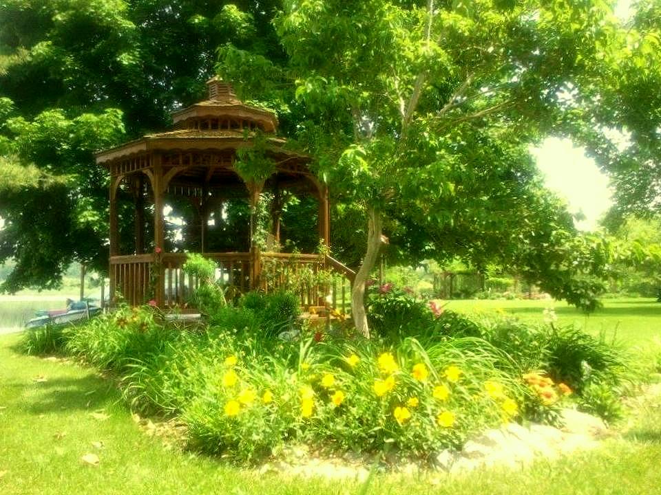 Cedar Gazebo with yellow Coreopsis and Gallardia in foreground